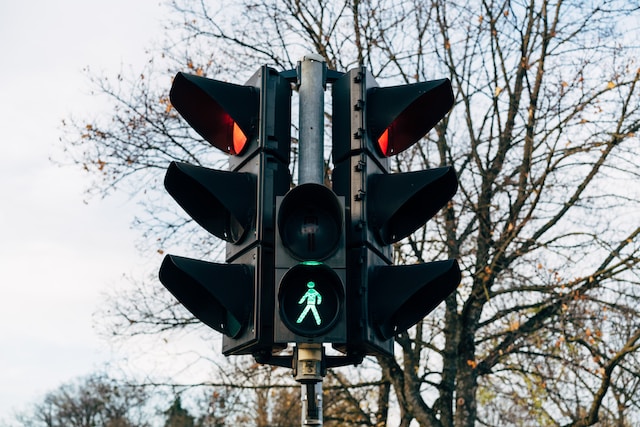 Traffic light showing green for pedestrians and red for cars.
